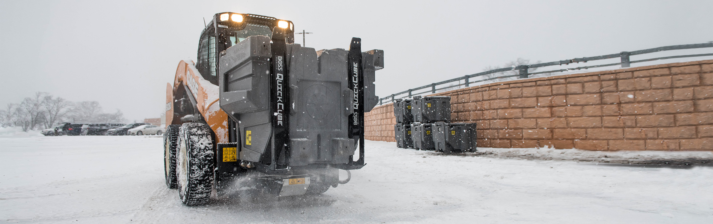 Image of Skid Steer and BOSS QuickCube spreading salt in a parking lot