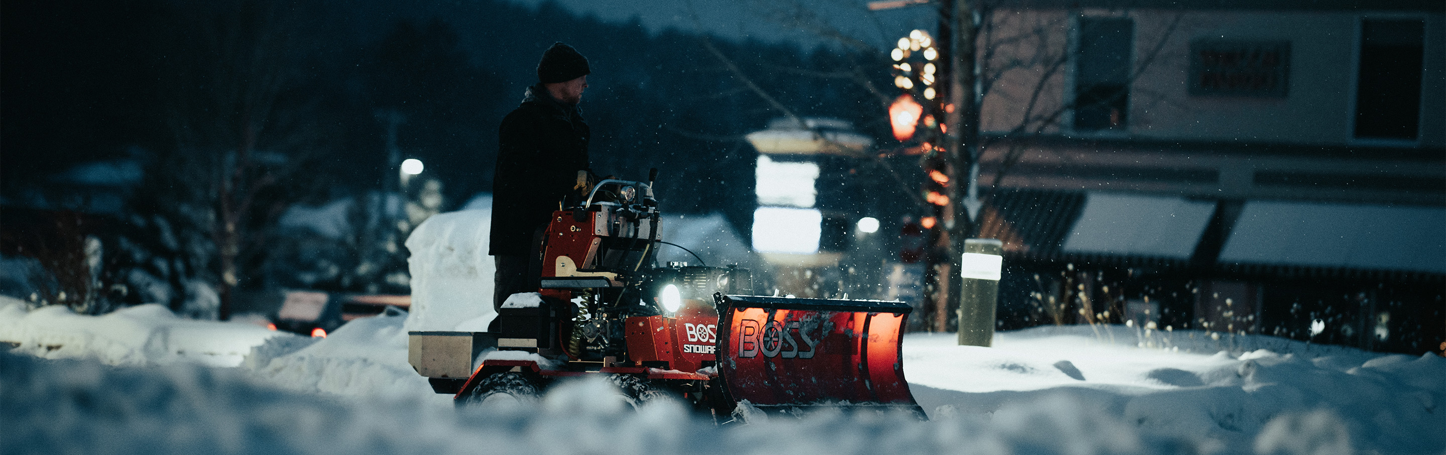 Photo of a Snowrator plowing a sidewalk during early morning