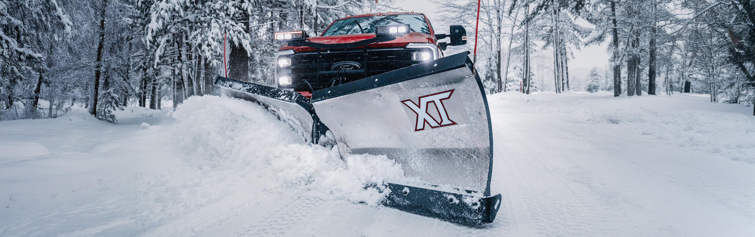 XT plowing snow in action hero banner