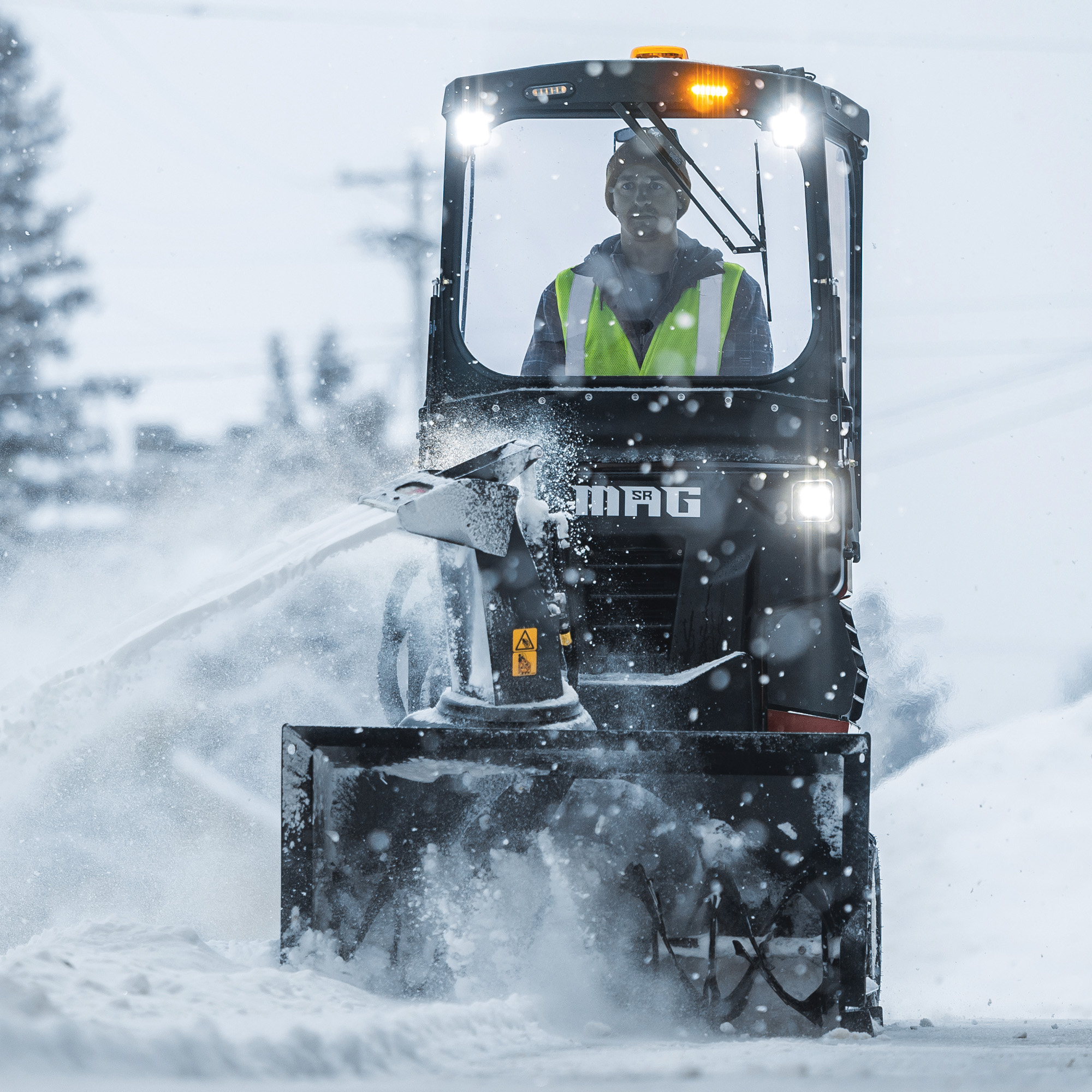 Sidewalk Brochure Image - SR Mag with Snow Blower Implement Clearing Snow